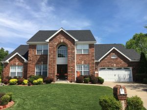 Brick house with manicured lawn