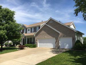 Two-story house with garage and lawn