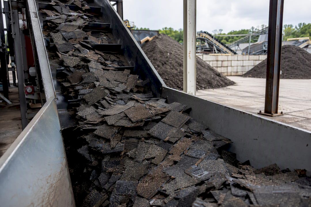 Asphalt shingles entering a recycling facility